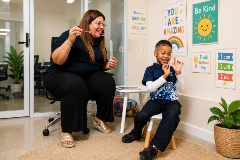Child playing with bubbles during therapy